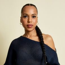 Kerry Washington in an asymmetrical top with a low braided ponytail hairstyle