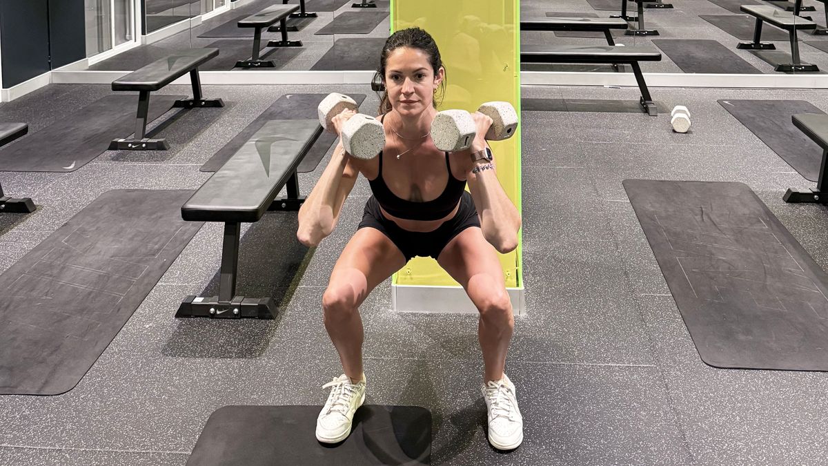 a photo of fitness writer Lucy Gornall doing a dumbbell thruster
