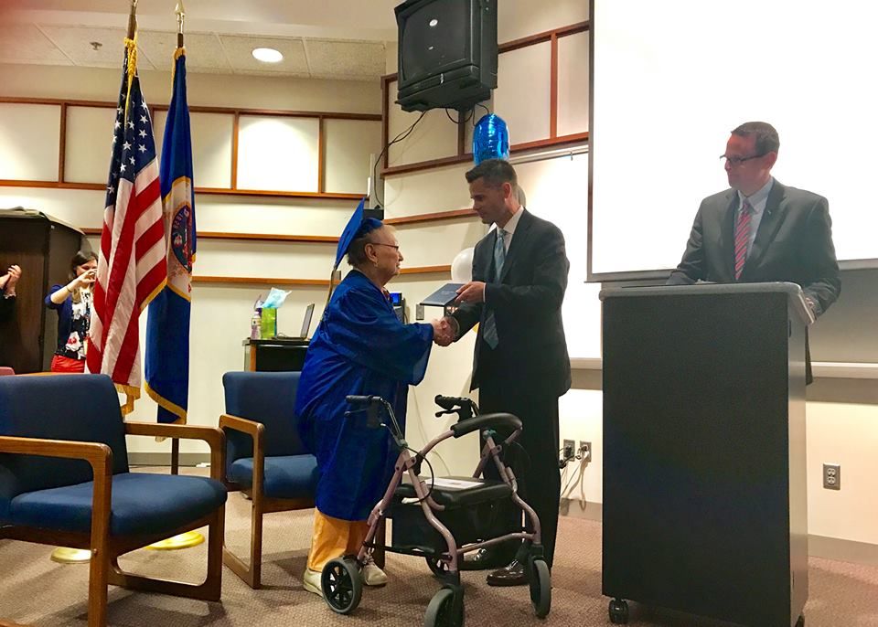 Esther Begam receives her high school diploma.