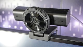 The Razer Kiyo V2 webcam perched on top of a monitor with pegboard behind it