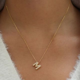 Image of woman wearing M initial necklace