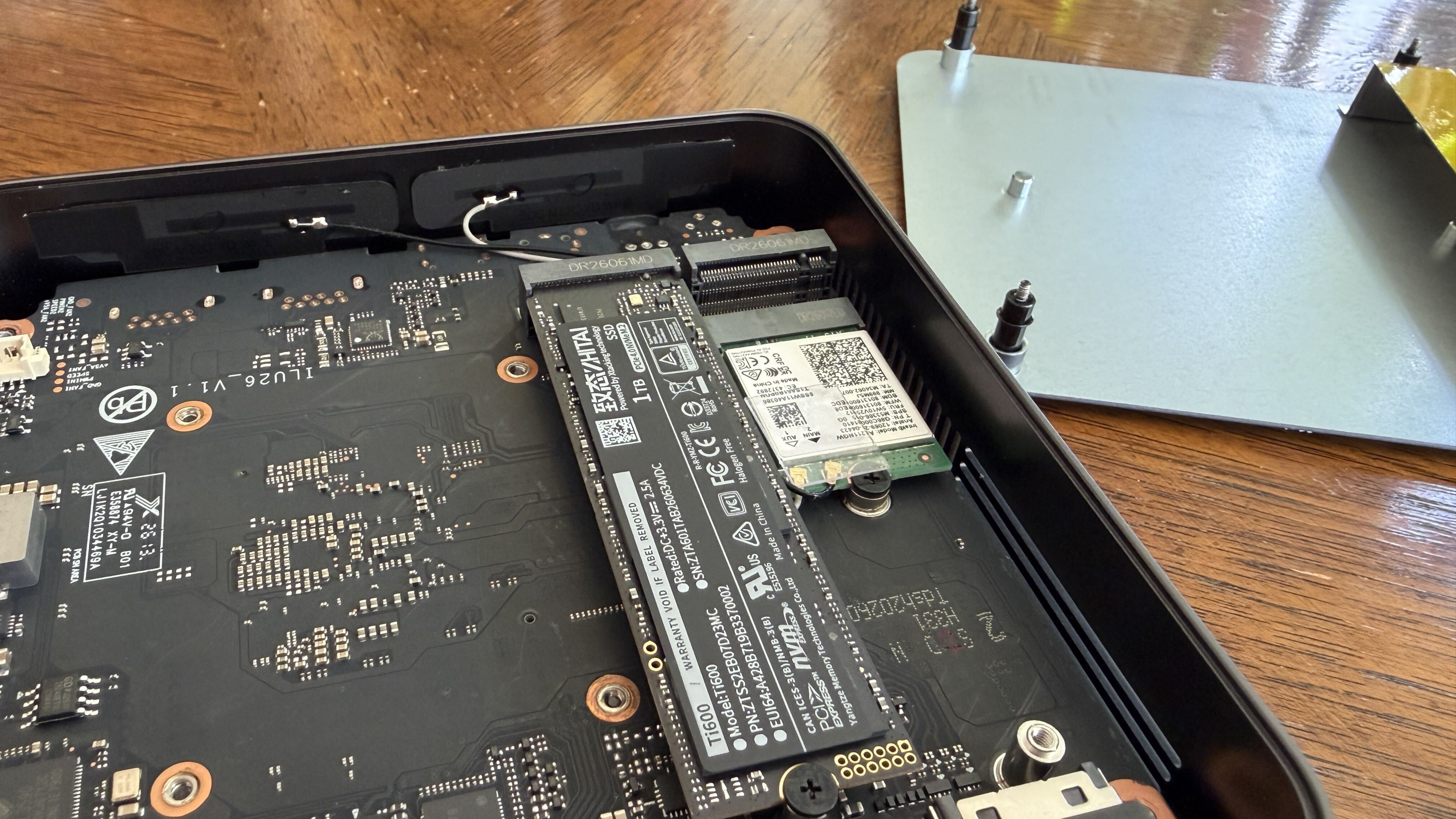 Interior of a Chuwi mini PC showing a circuit board with an SSD and other components.