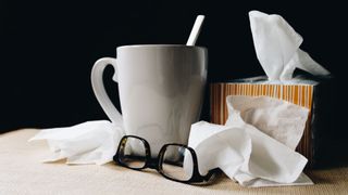 Mug, glasses and used tissues