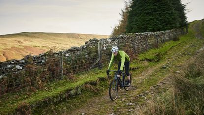 Image shows a person riding their first gravel bike.