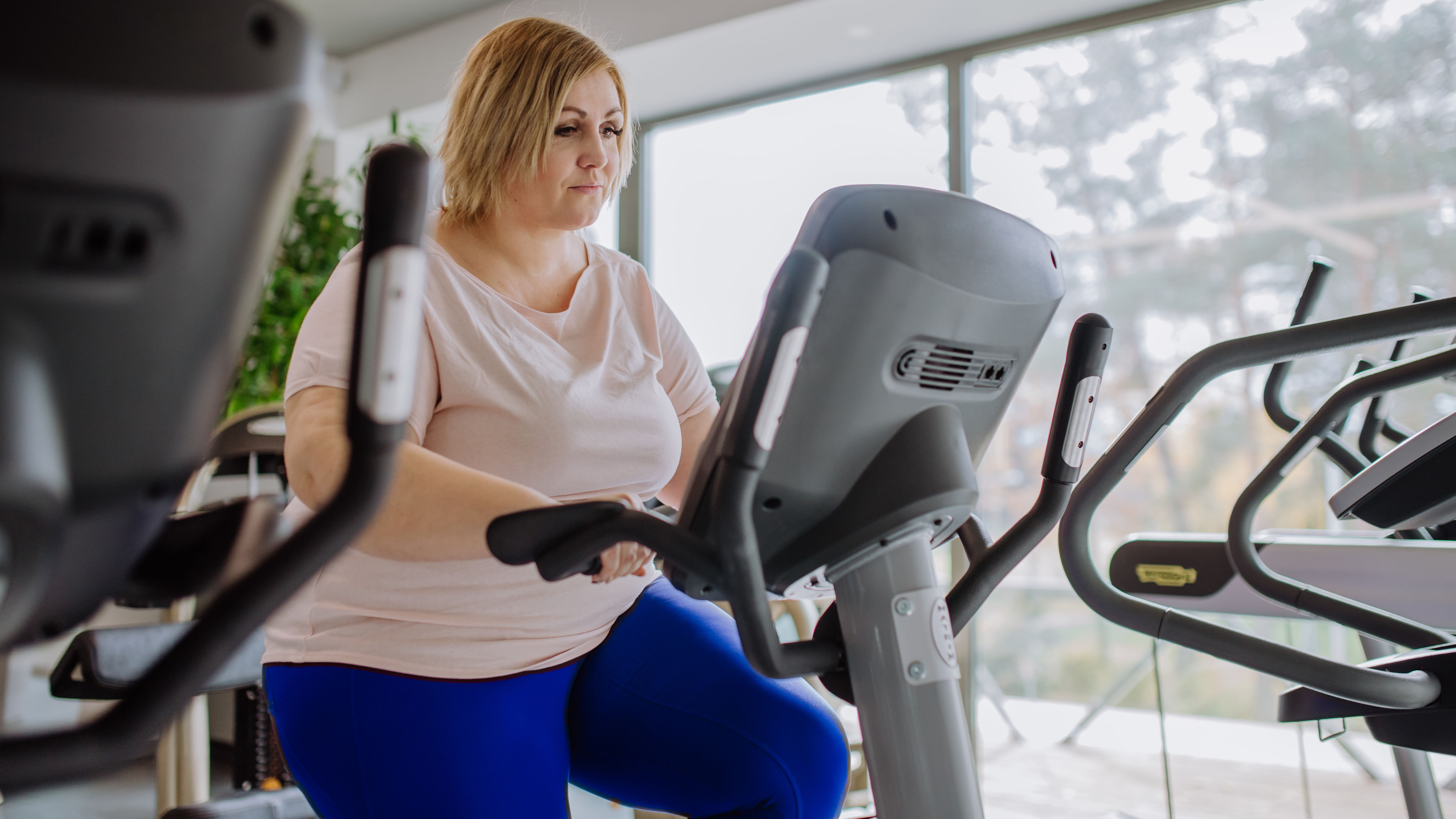 Woman on exercise bike at gym