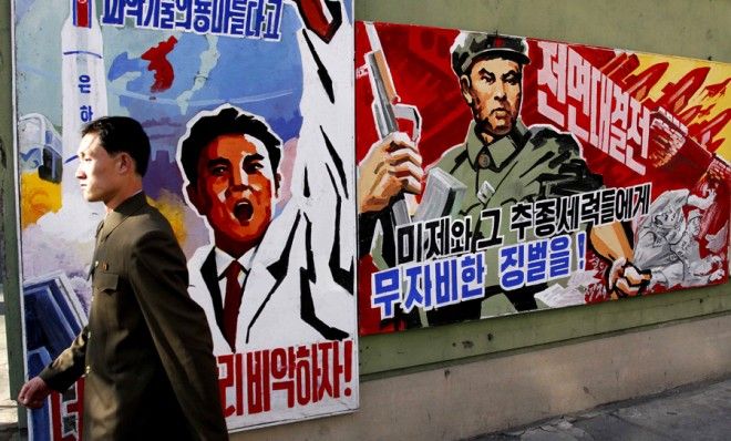 A man walks past propaganda posters in Pyongyang, North Korea on March 26.