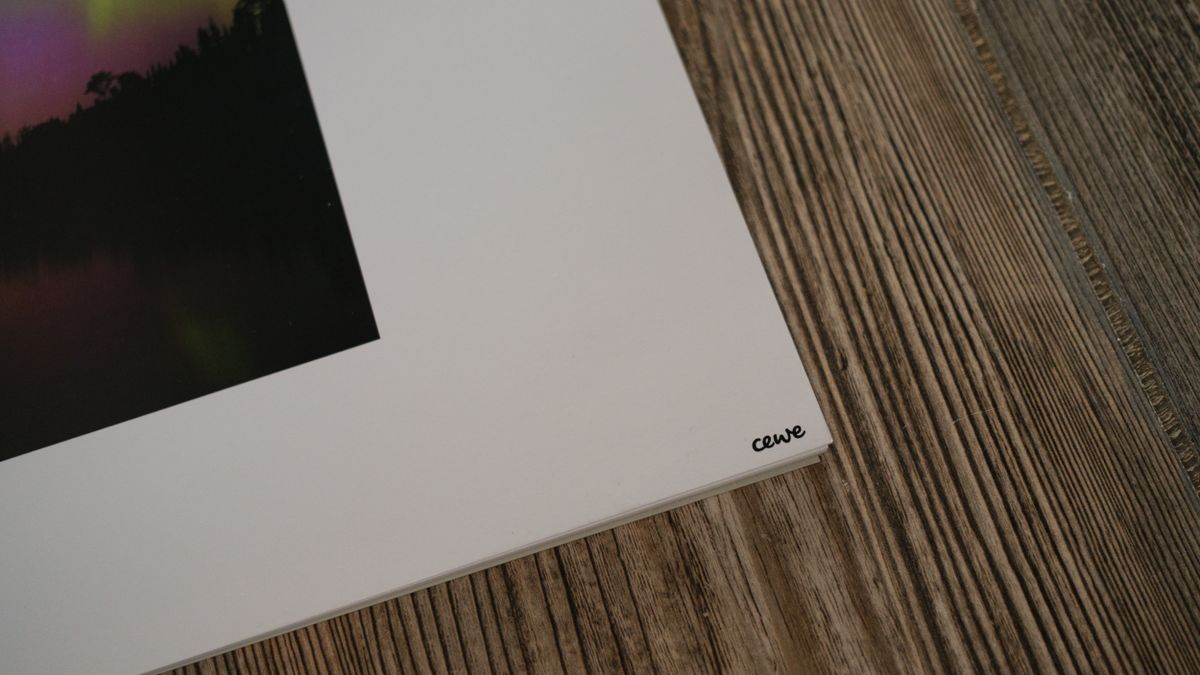 A photo calendar from CEWE on a wood background