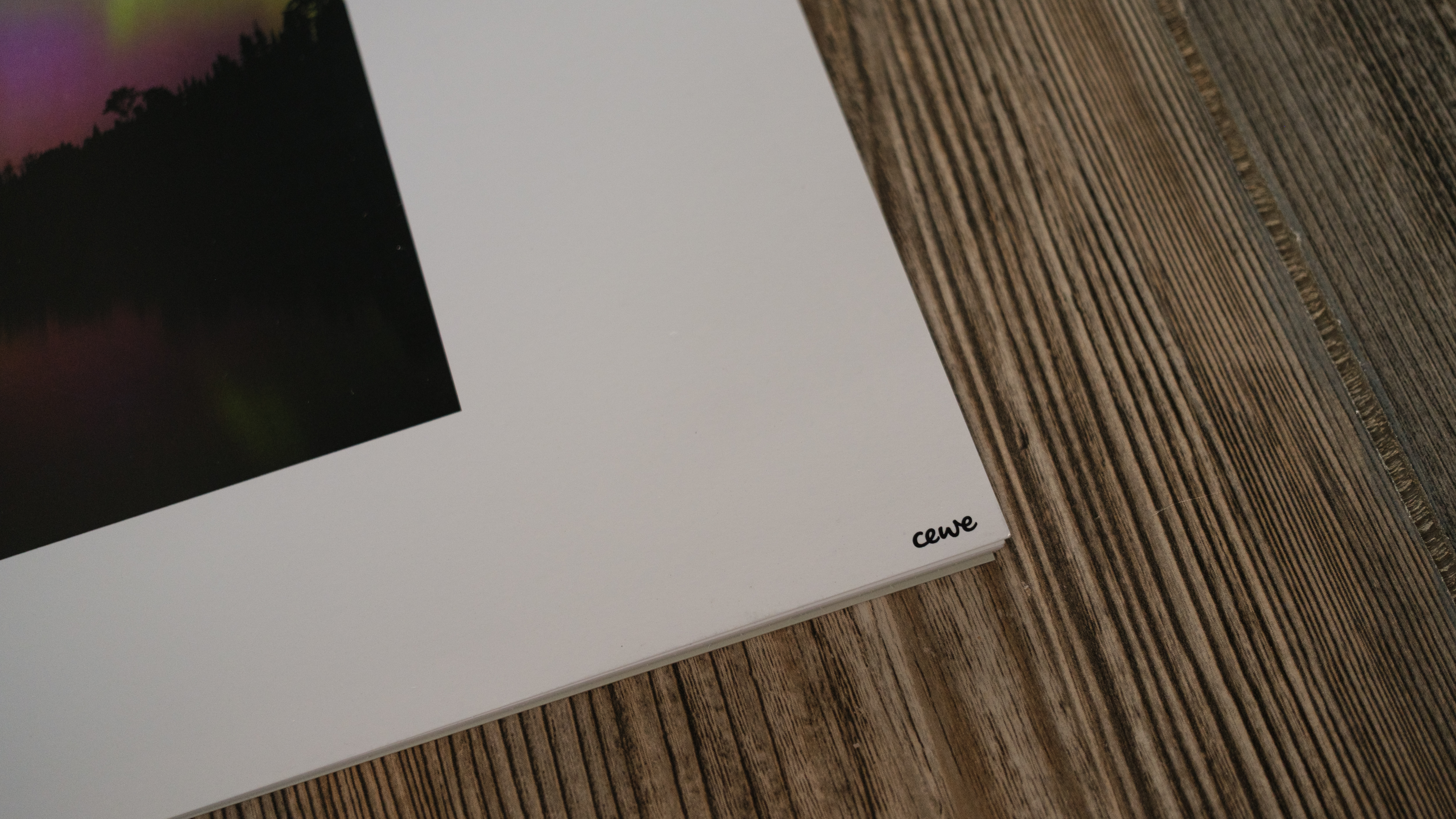 A photo calendar from CEWE on a wood background