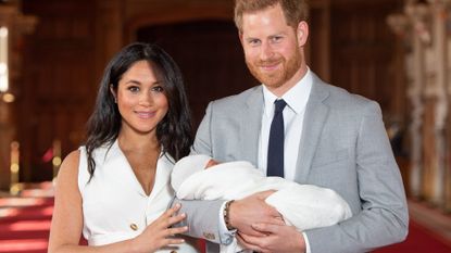 Prince Harry, Duke of Sussex and Meghan, Duchess of Sussex, pose with their newborn son Archie Harrison Mountbatten-Windsor during a photocall in St George's Hall at Windsor Castle on May 8, 2019 in Windsor, England. The Duchess of Sussex gave birth at 05:26 on Monday 06 May, 2019