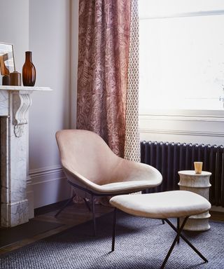 Living room corner with pale pink armchair and global influences