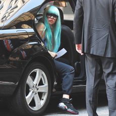 Amanda Bynes getting out of the back of a car.