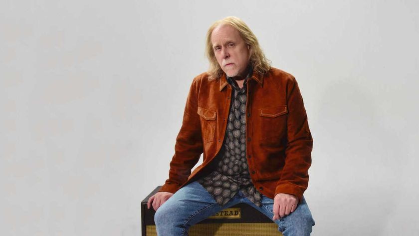 Warren Haynes sitting on an amplifier, studio portrait 