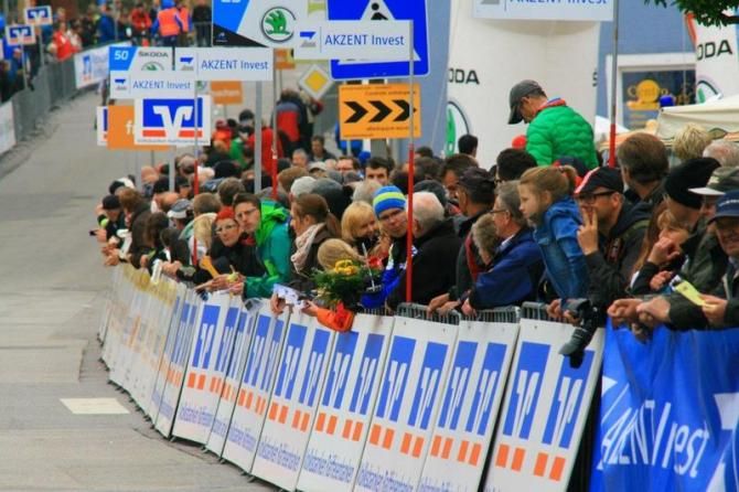 Fans cheer for the riders as they approach the finish line