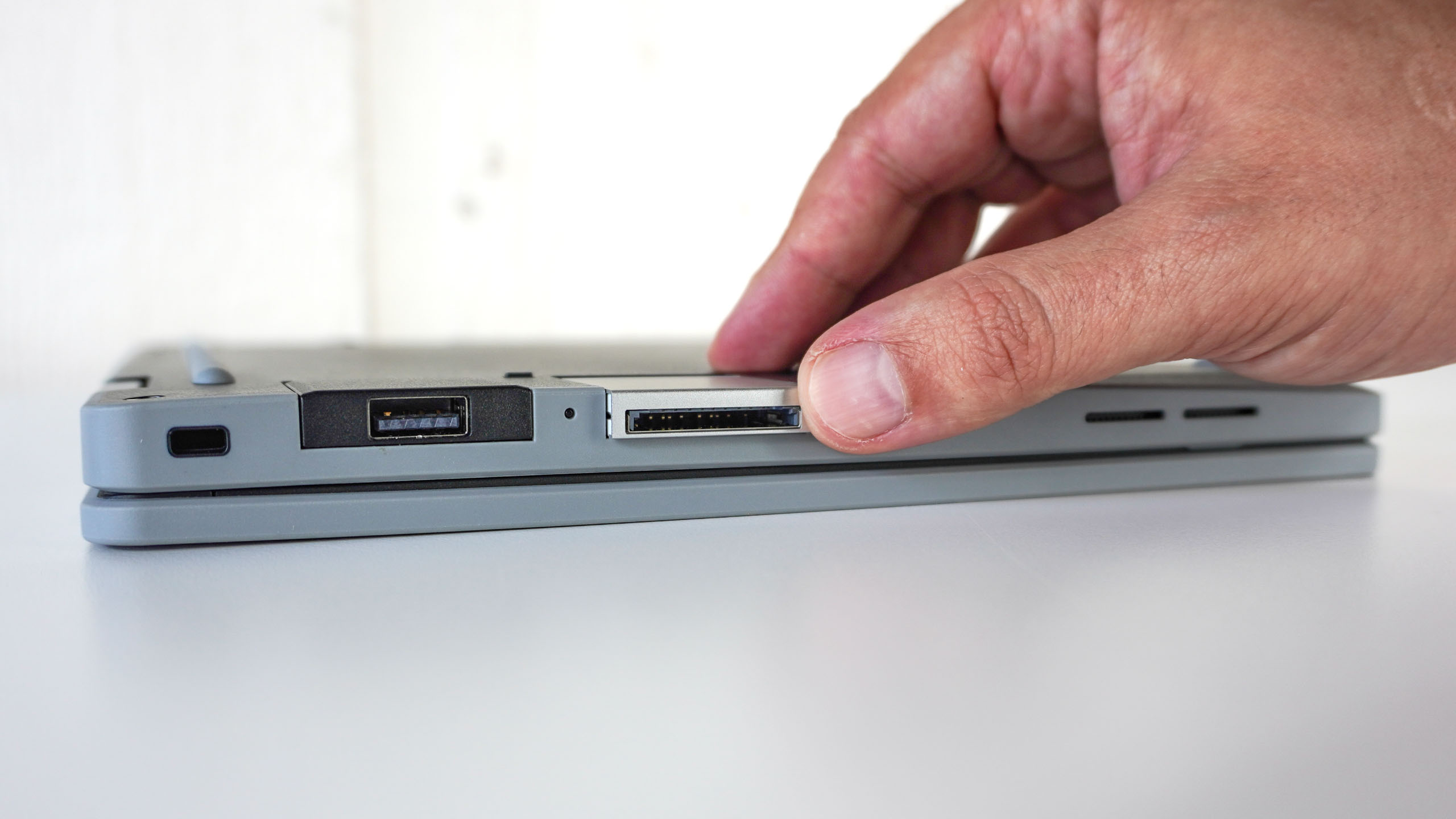 A person installing an Expansion Card on the Framework Laptop 12