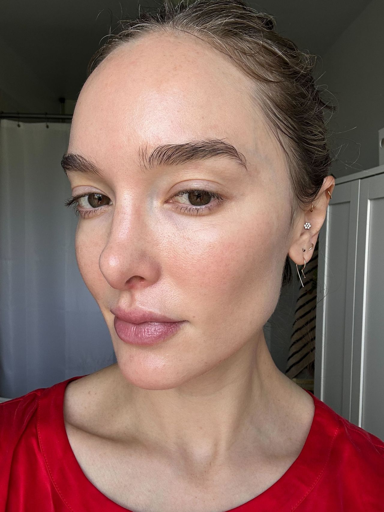 A girl with a red shirt after applying SPF.