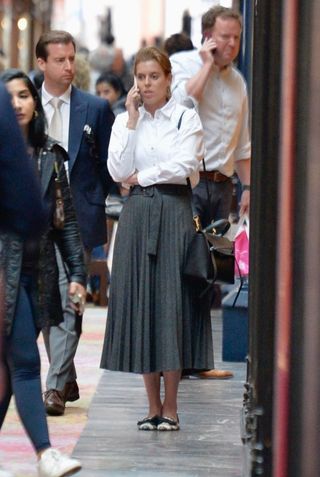 Princess Beatrice shops in London wearing a white button down and pleated skirt