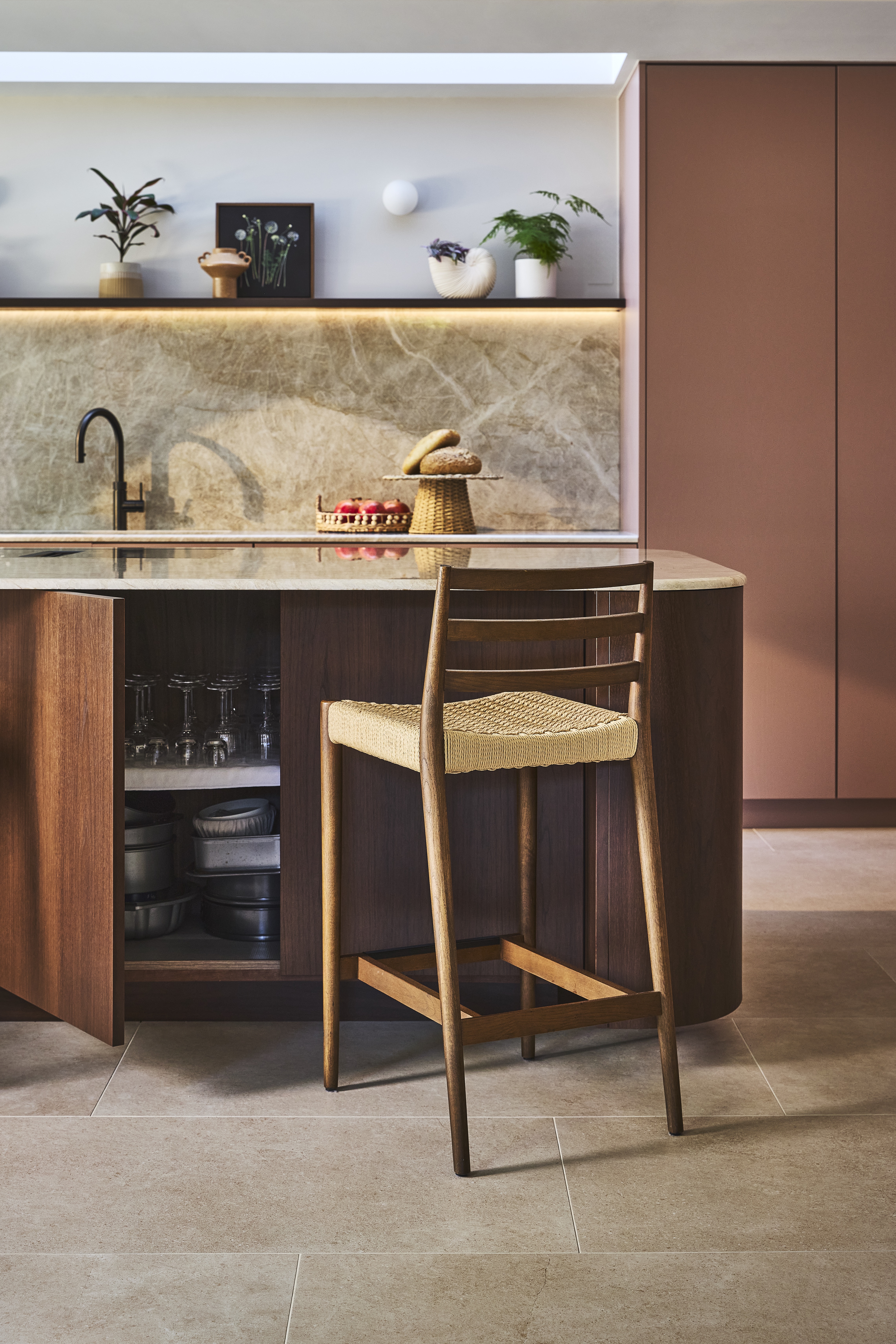 open cabinet under kitchen island with rattan bar stool