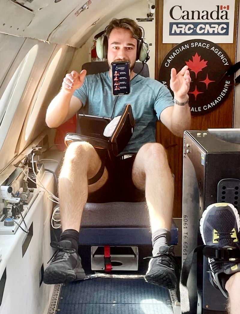 a person floating on a chair during a parabolic flight