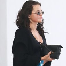 Selena Gomez wore all-black loungewear with a backless pair of Mary Janes
