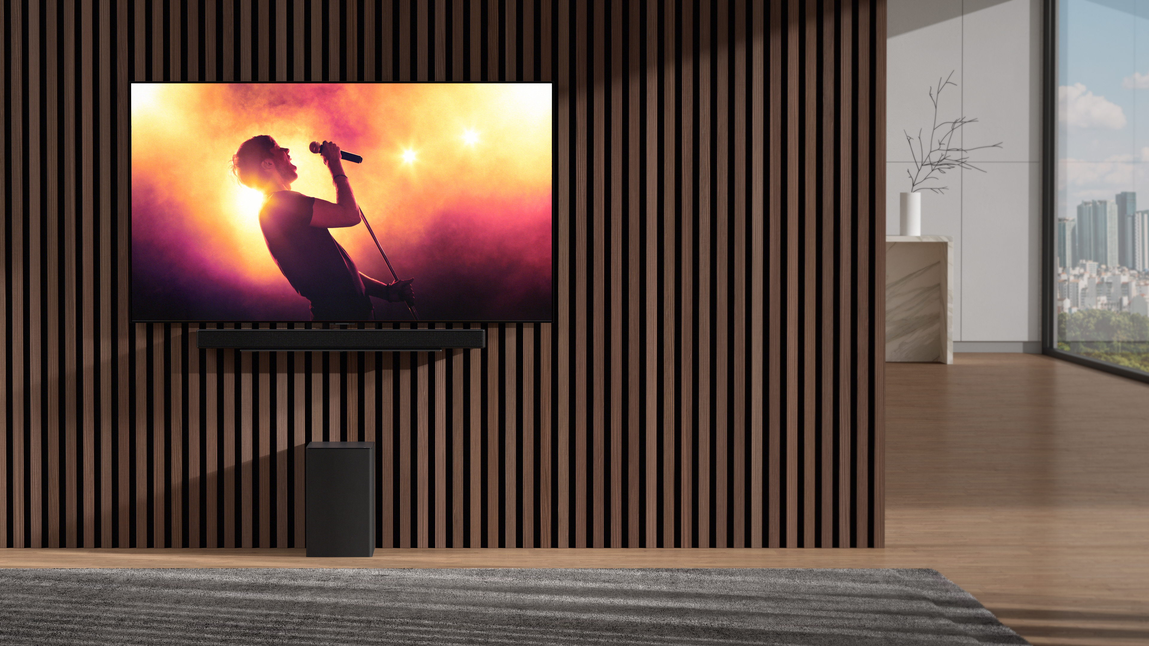 LG SC9 soundbar under TV against wood paneled wall
