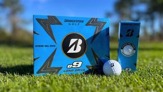 Bridgestone e9 golf Ball resting on the fairway with it s packaging