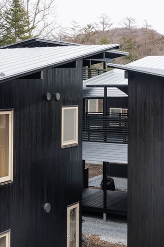 shishi-iwa house in japan with dark wood exterior