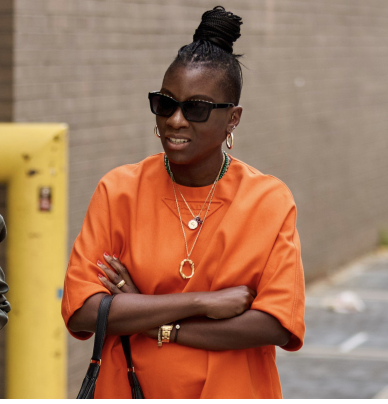 nikki ogunnaike wearing an orange dress