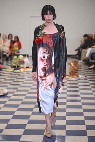 Woman on runway in Puppets & Puppets dress with printed face