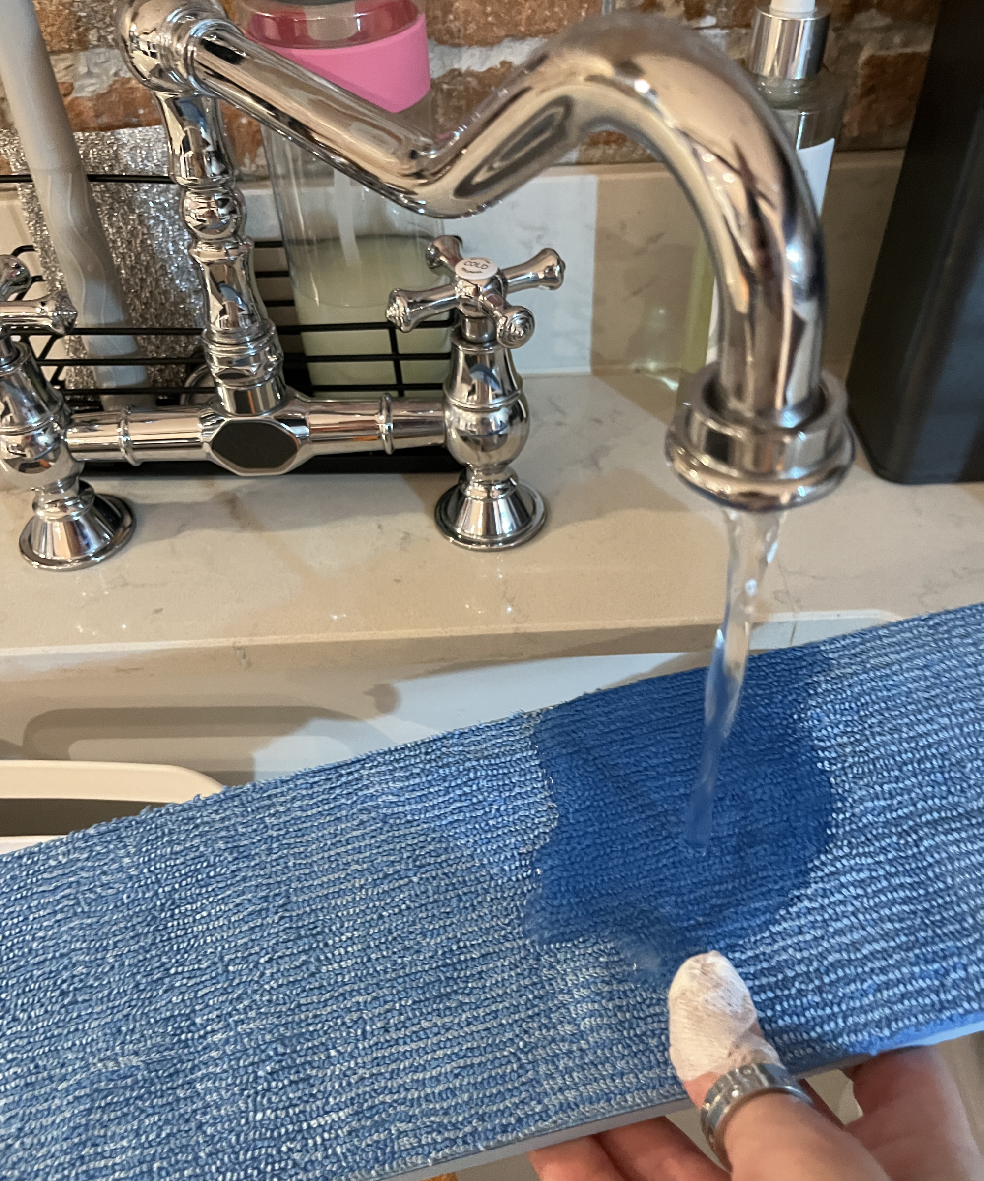 wetting the mop head of the Philips OneUP 5000 series electric mop