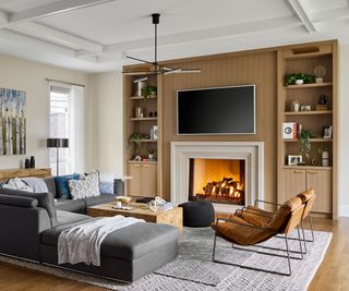 Cozy living room with bespoke wooden shelving surrounding fire