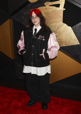 Billie Eilish, nominated for "What Was I Made For," on the red carpet in a Barbie-themed look.