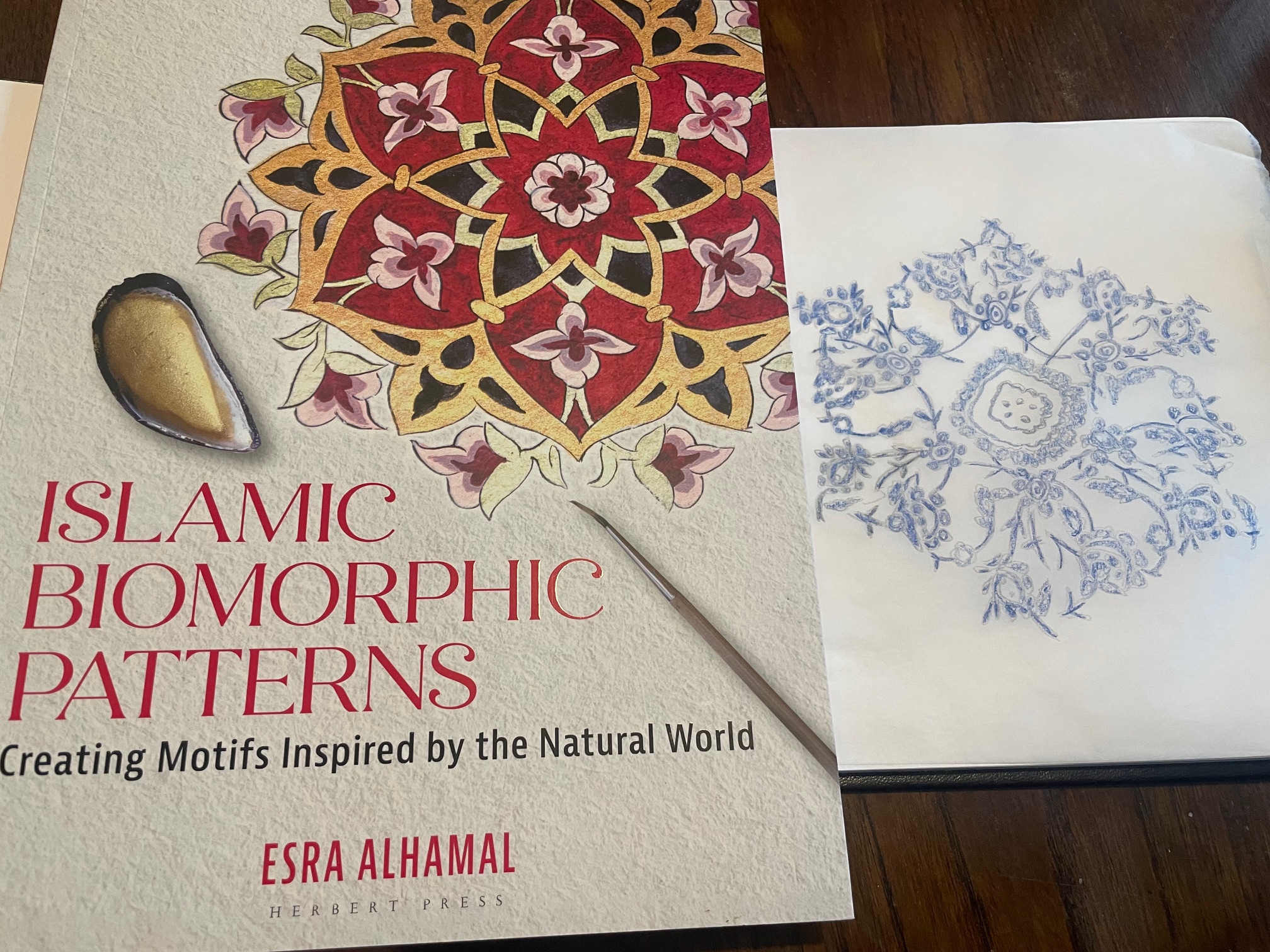 Islamic Biomorphic Patterns book next to drawing created from book of a pattern