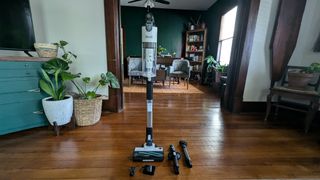 Levoit LVAC-200 cordless vacuum, standing upright, next to supplied accessories, in reviewer's home