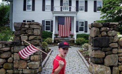 A boy waves a flag during the annual Memorial Day Parade in New Canaan, Conn., one of the wealthiest communities in the U.S.: According to a new report, the median family income dropped 8 per