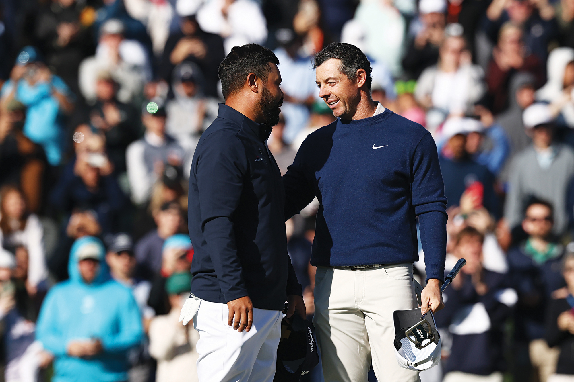 JJ Spaun being consoled by Rory McIlroy after McIlroy won The Players Championship in a playoff at TPC Sawgrass