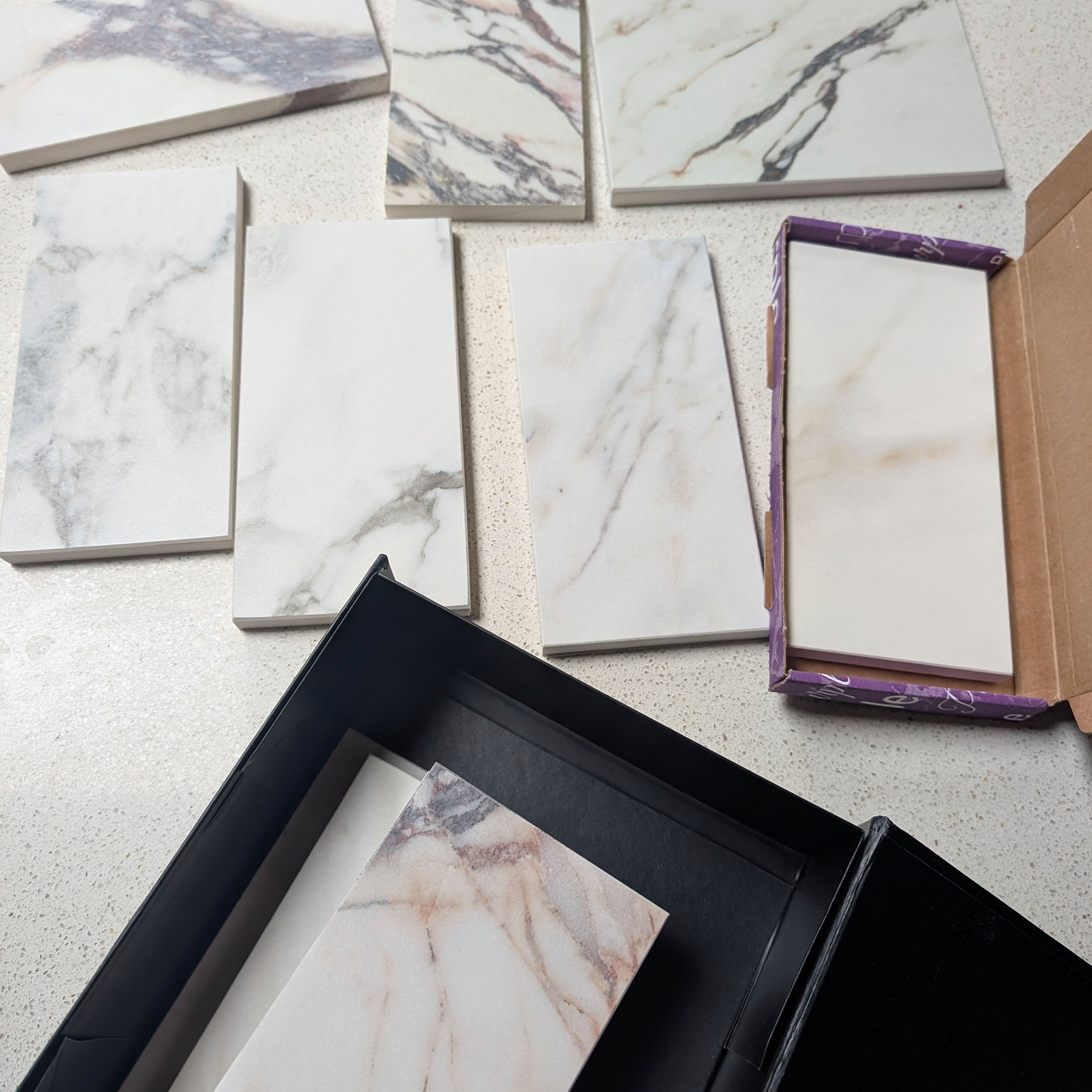 Selection of white stone samples laid out on table