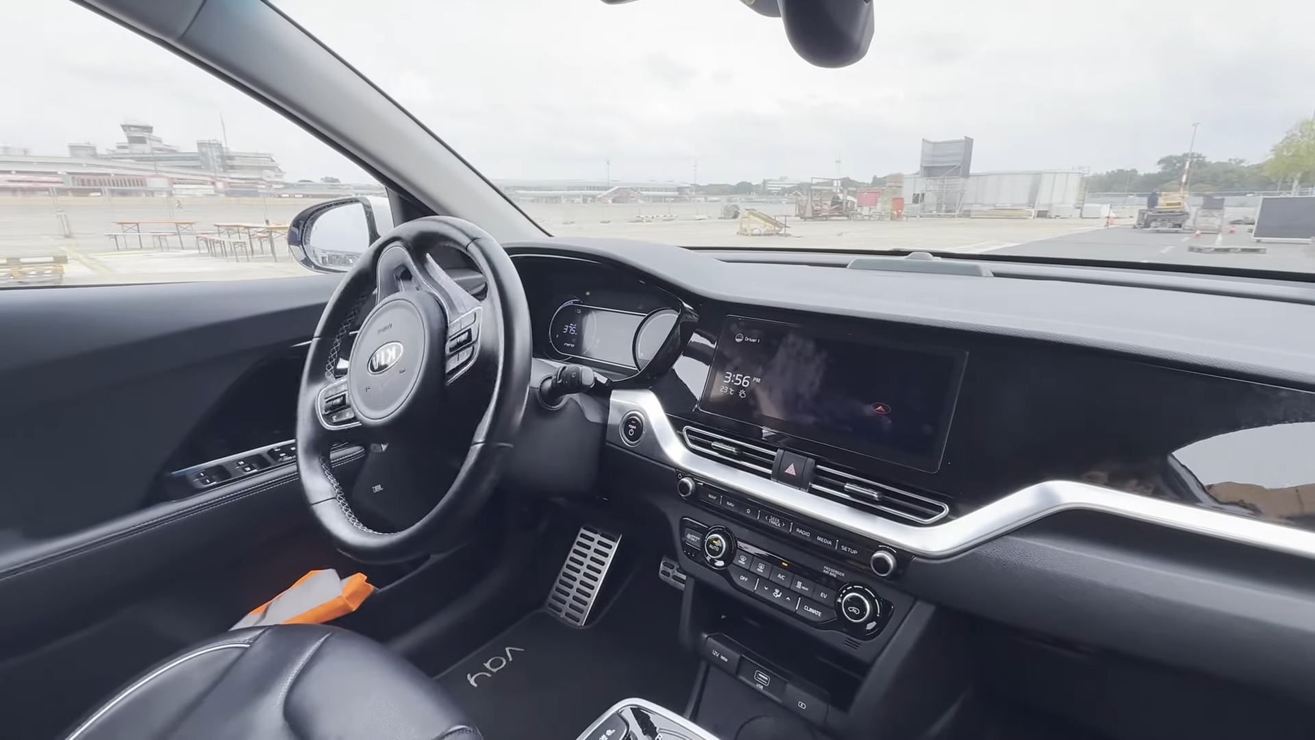 A driver remotely controls a car on the defunct Tegel airport runway.