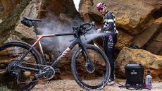 Alec Briggs using the Muc-Off Pressure Mobile Pressure Washer on a Canyon gravel bike