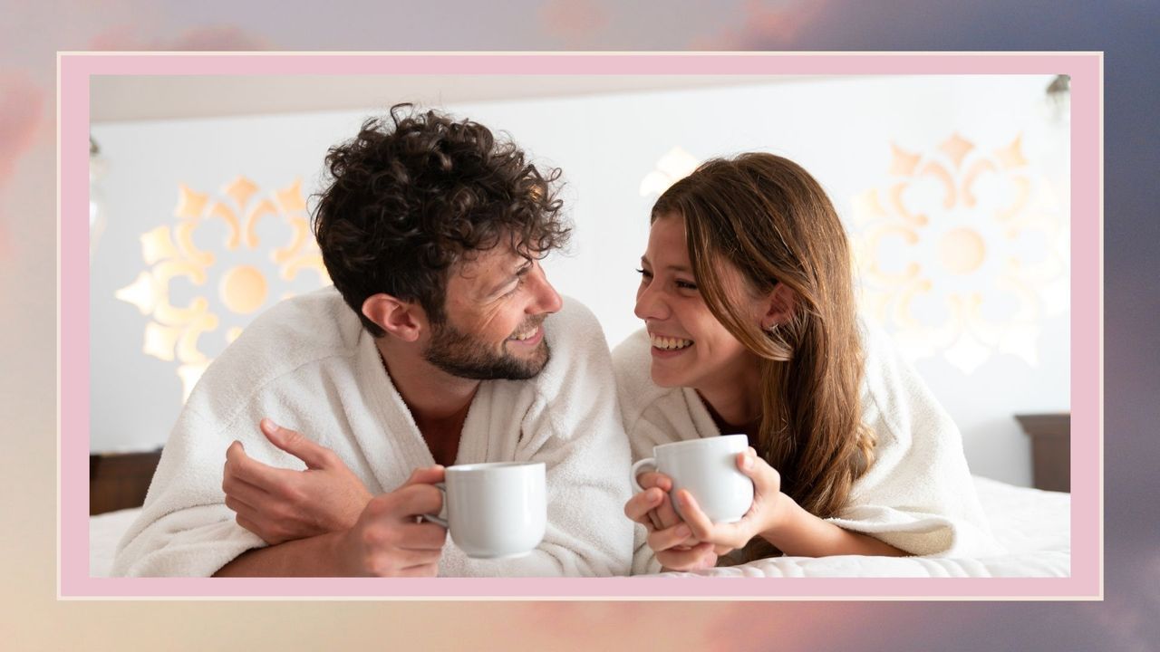 Couple in bathrobes in bed having tea