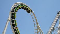 A roller coaster goes into a loop upside down.