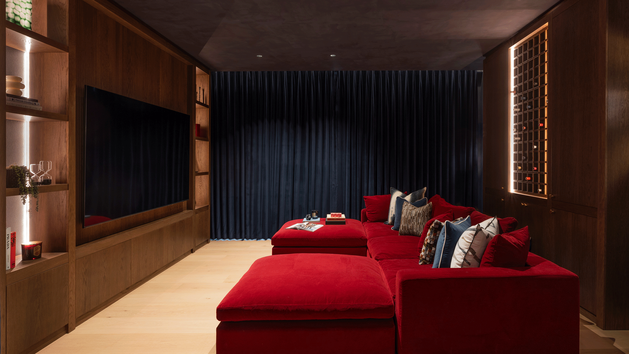 a cinema room with a dark red sofa