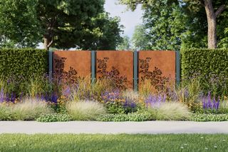 decorative corten fence along garden boundary with hedges