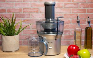 The Breville Juice Fountain Compact BJE200XL on a desk