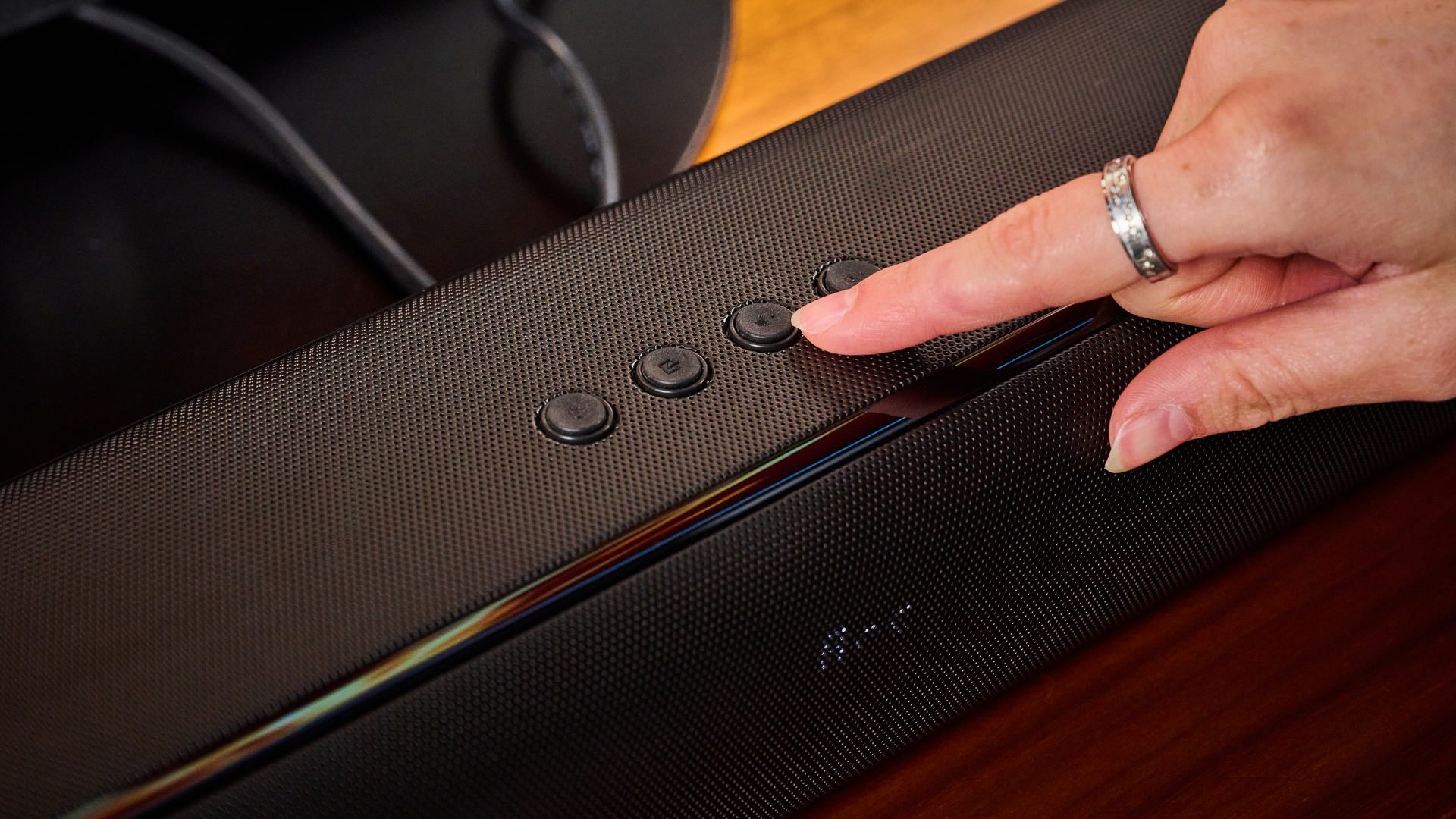 the budget majority naga 60 soundbar in black, showing its buttons and remote