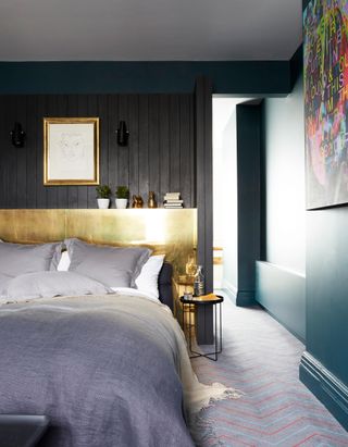 Black and blue bedroom with gold headboard