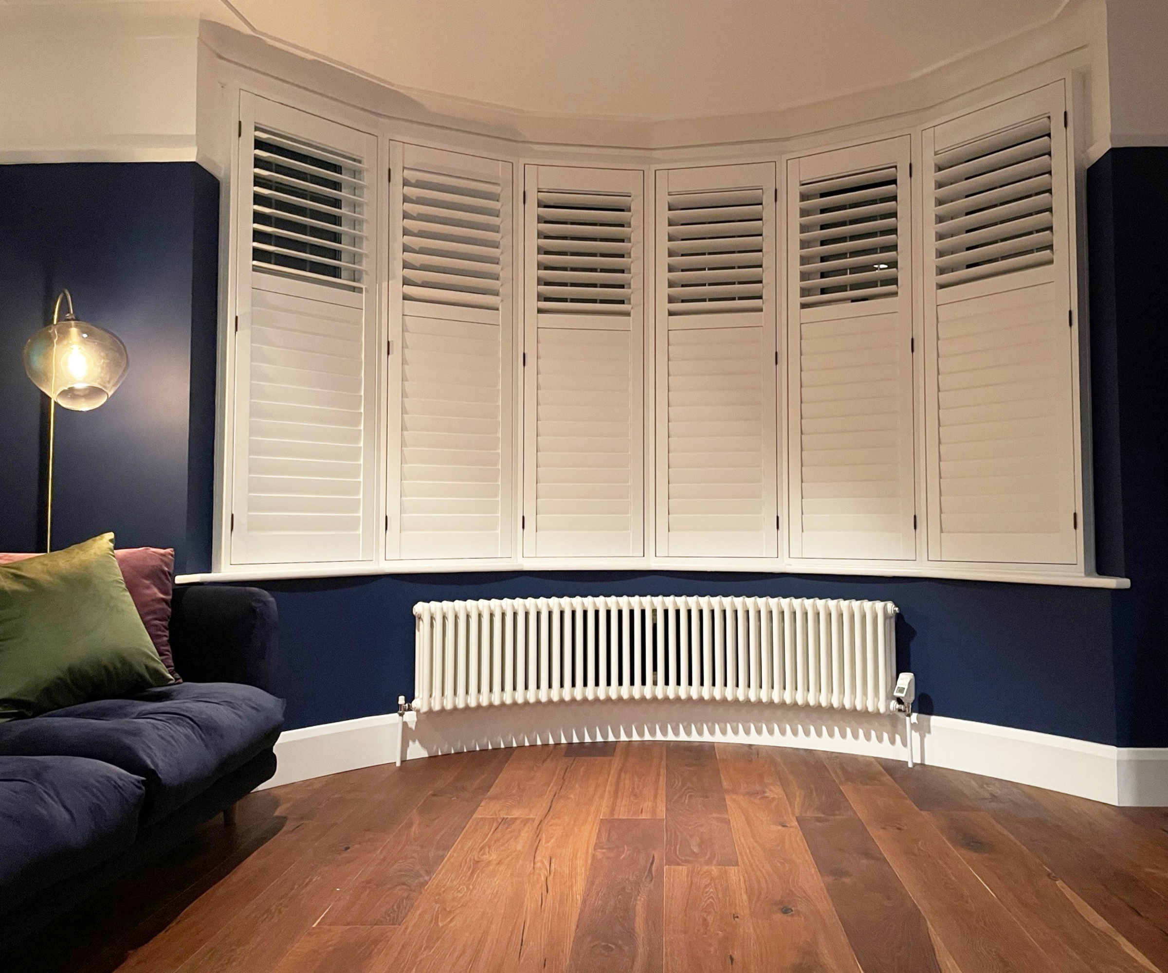 curved white low level column radiator in curved bay window