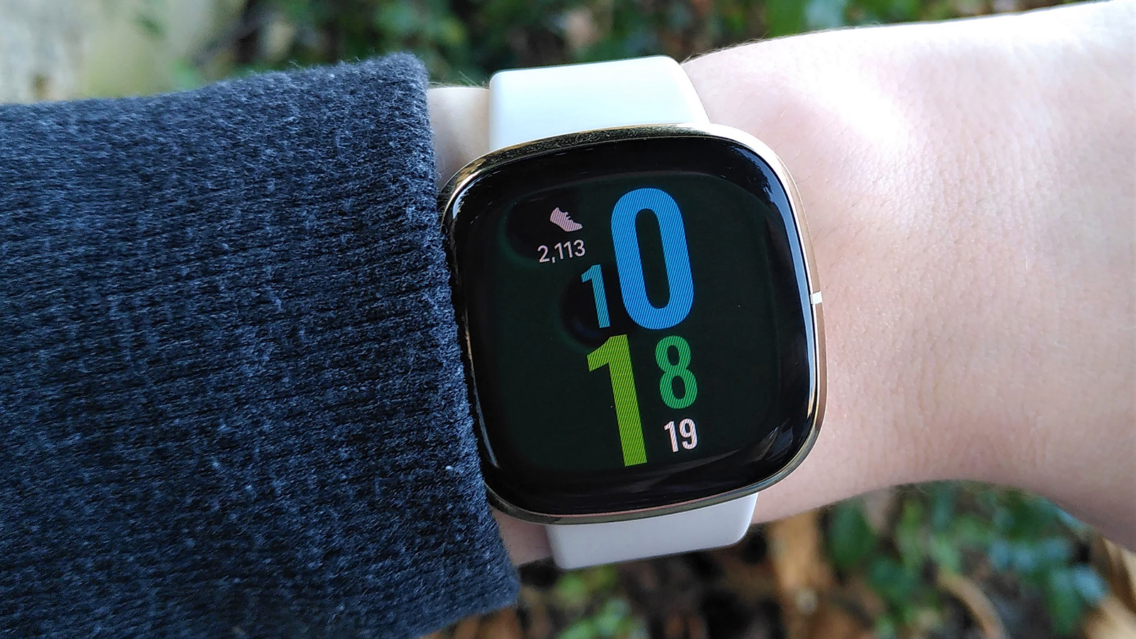 The Fitbit Sense on a wrist with the time displayed