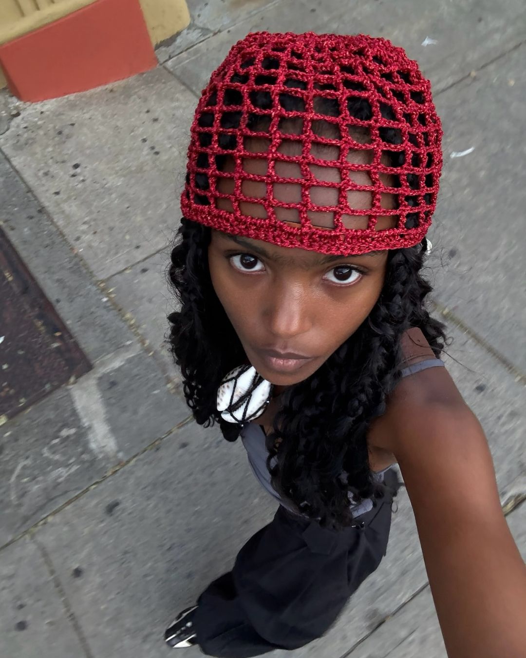 A woman wearing a crochet cap.