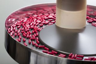 Pills on pharmaceutical production equipment.