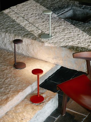 Coloured oblique desk lights on stone floor